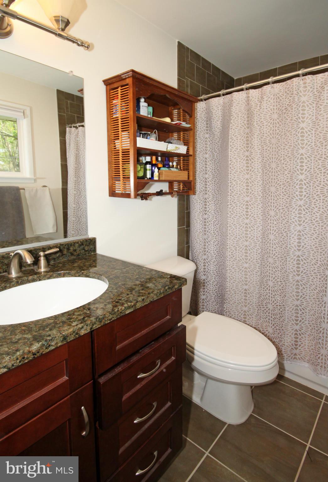 5420 Inverchapel Road Springfield, VA 22151 - Photo 13 of 29 a bathroom with a granite countertop sink toilet and shower