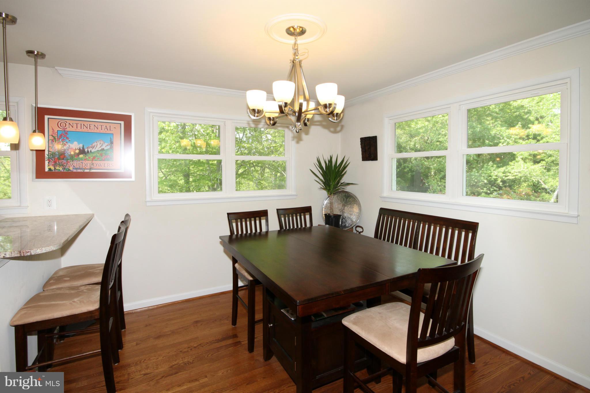 5420 Inverchapel Road Springfield, VA 22151 - Photo 6 of 29 a view of a dining room with furniture a chandelier and wooden floor