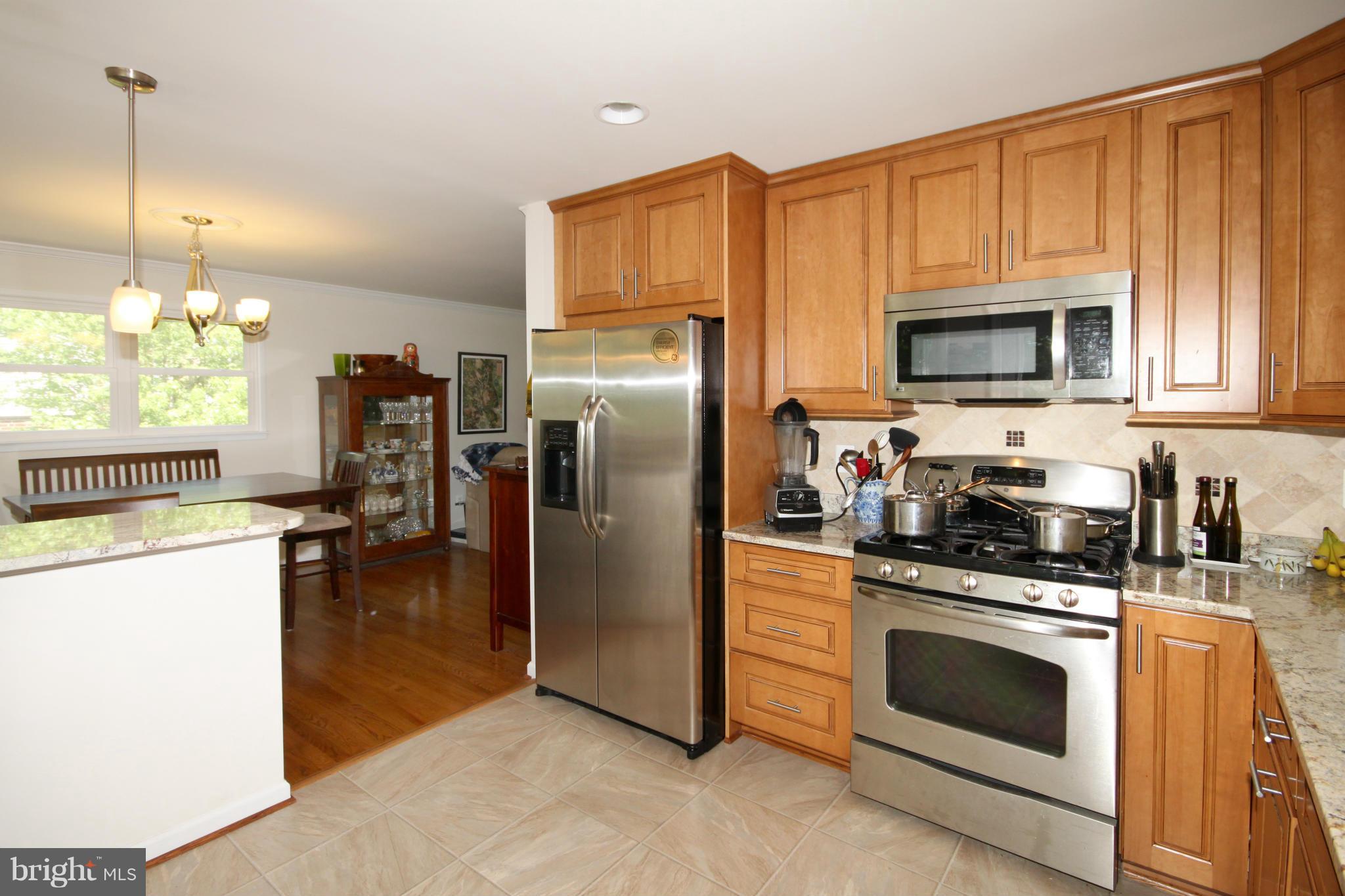 5420 Inverchapel Road Springfield, VA 22151 - Photo 9 of 29 a kitchen with a stove a sink and a refrigerator