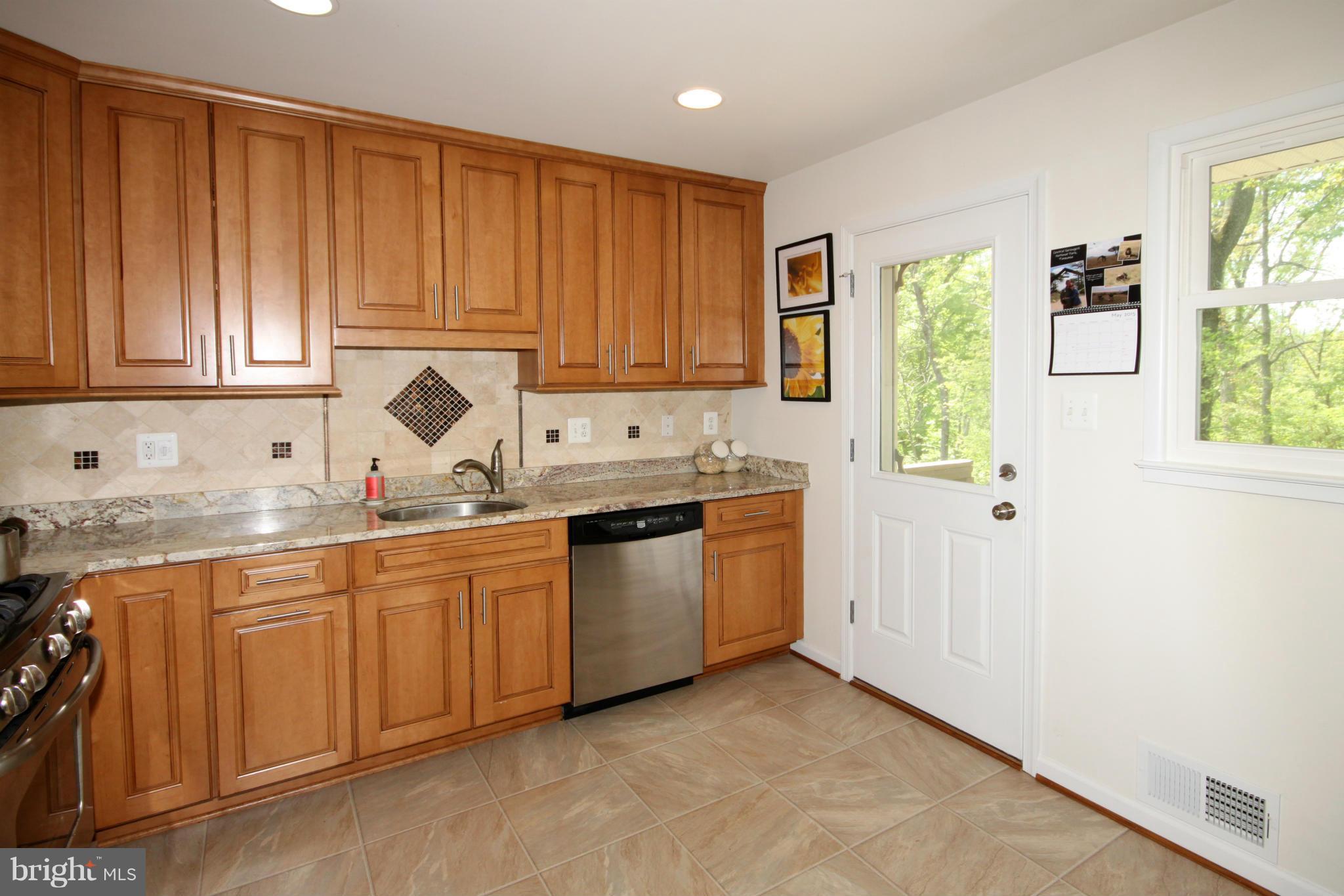 5420 Inverchapel Road Springfield, VA 22151 - Photo 10 of 29 a kitchen with granite countertop a sink window and cabinets