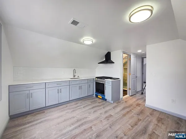 a kitchen with a sink cabinets and window
