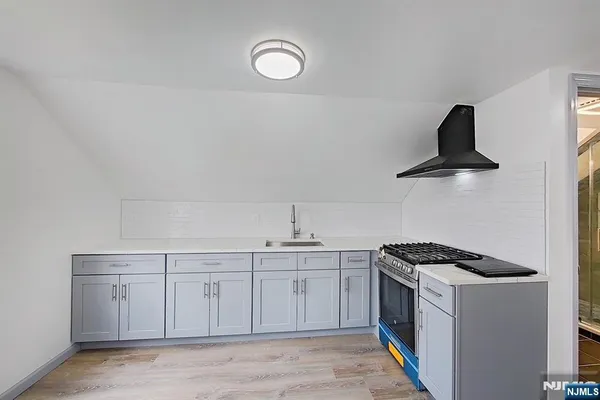 a kitchen with a sink and a stove