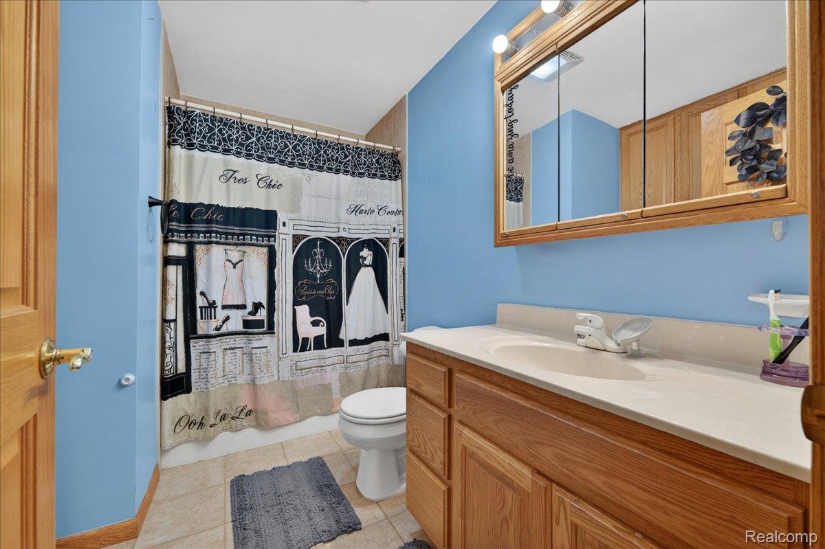 4049 Slattery Road North Branch, MI 48461 - Photo 24 of 45 Bathroom with a shower with shower curtain, vanity, and light tile patterned floors