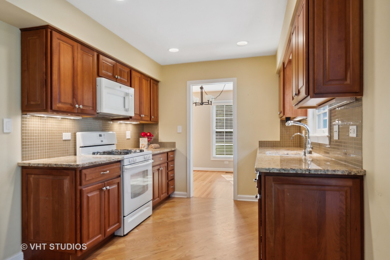 2425 Pfingsten Road Glenview, IL 60026 - Photo 7 of 22 a kitchen with granite countertop a sink stove and cabinets