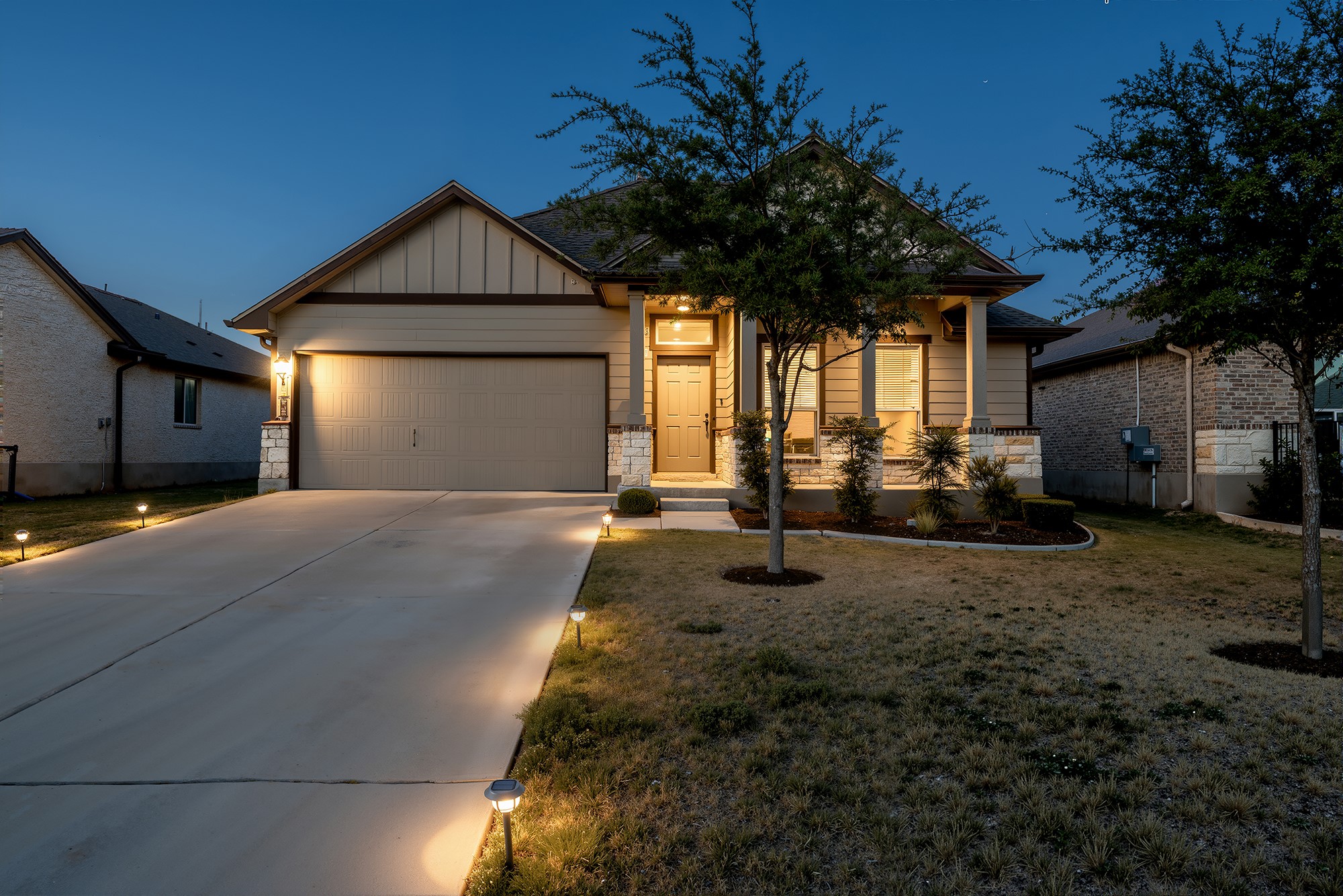 5812 Copano Road Belton, TX 76513 - Photo 1 of 1 Craftsman house with board and batten siding, concrete driveway, stone siding, an attached garage, and a front lawn
