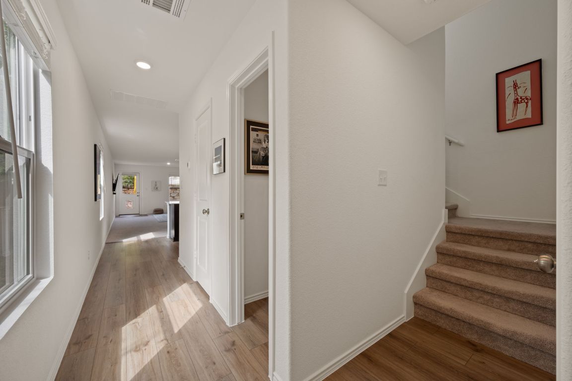 68 Trinity Circle Lockhart, TX 78644 - Photo 14 of 27 a view of a hallway with wooden floor and staircase