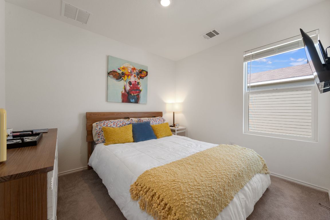 68 Trinity Circle Lockhart, TX 78644 - Photo 18 of 27 a bedroom with a bed and a window