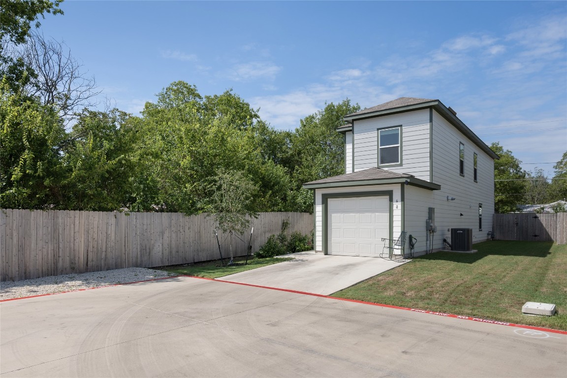 68 Trinity Circle Lockhart, TX 78644 - Photo 2 of 27 a front view of a house with a yard and garage