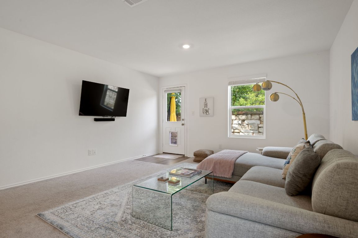 68 Trinity Circle Lockhart, TX 78644 - Photo 5 of 27 a living room with furniture and a flat screen tv