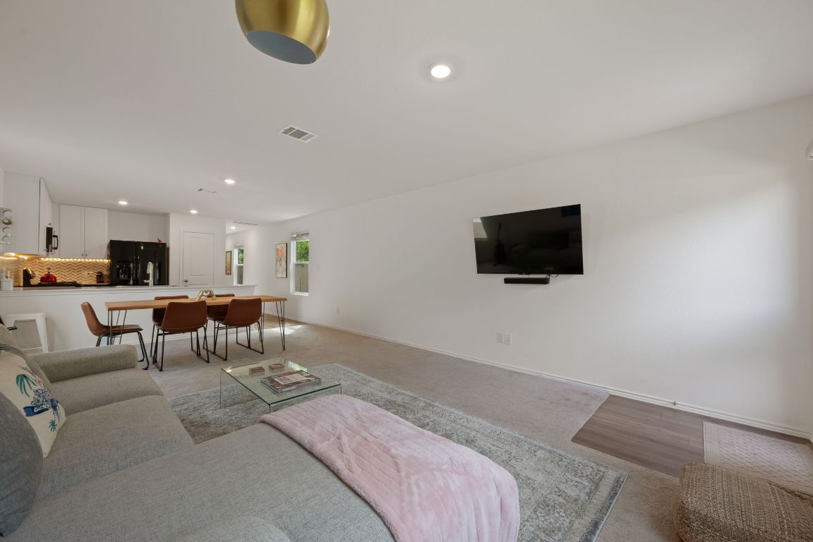 68 Trinity Circle Lockhart, TX 78644 - Photo 6 of 27 a living room with furniture and a flat screen tv