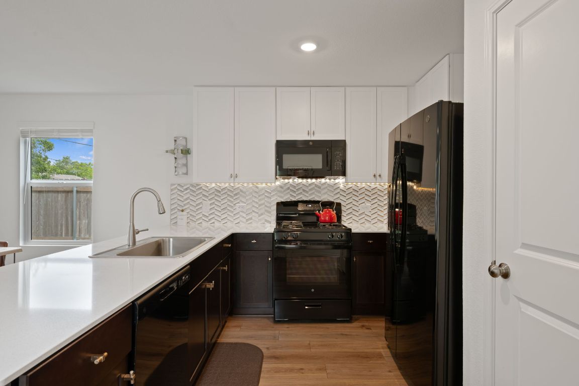 68 Trinity Circle Lockhart, TX 78644 - Photo 7 of 27 a kitchen with a refrigerator and a sink