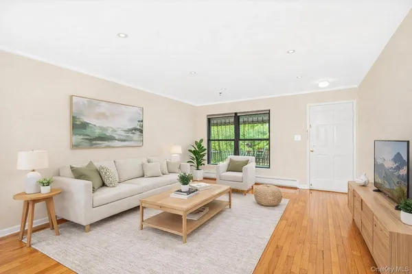 a living room with furniture a rug and a flat screen tv