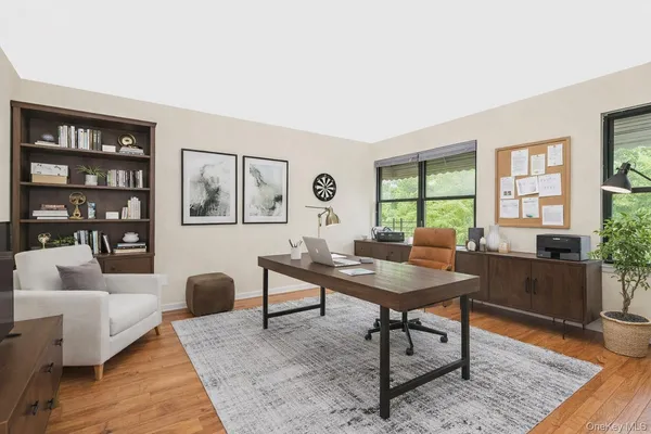 a view of a workspace with furniture window and wooden floor