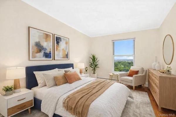 a bedroom with bed a couch and large window