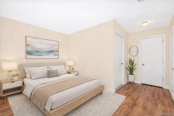 a bedroom with a bed and a painting on the wall