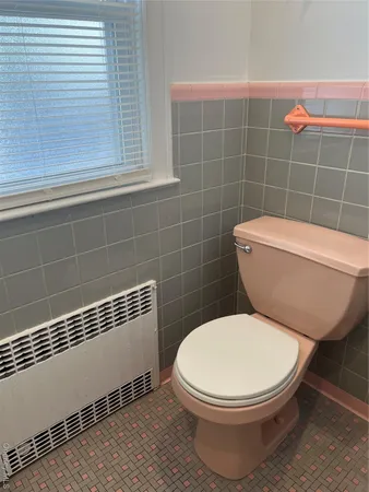 a white toilet sitting next to a bathroom sink
