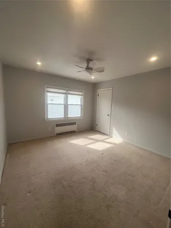 an empty room with a window and a fireplace