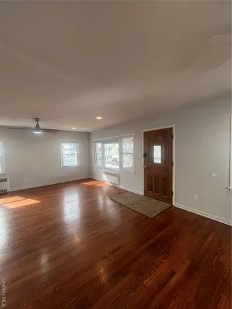 wooden floor in an empty room with a window