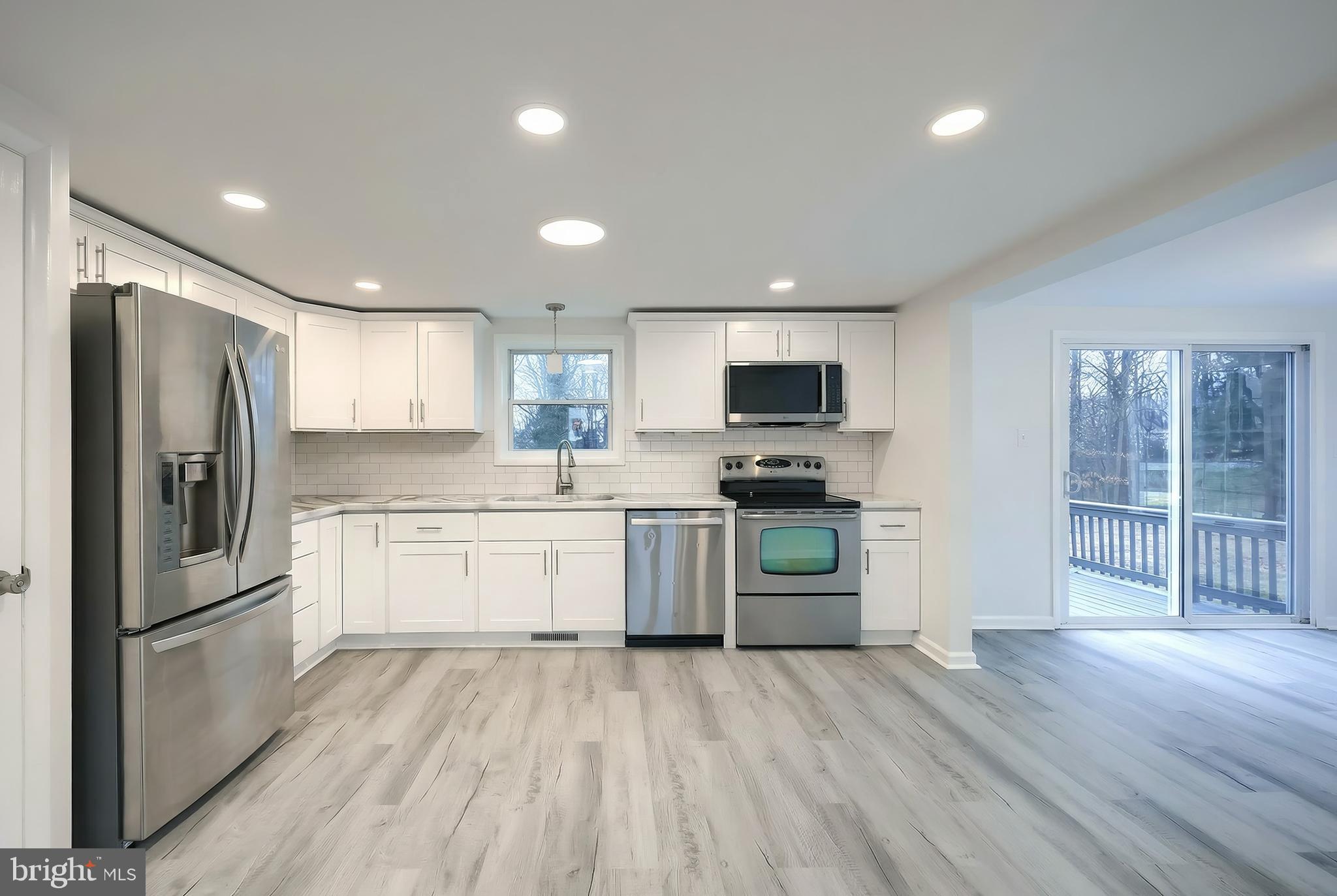 287 Chestnut Hill Road York, PA 17402 - Photo 34 of 36 a kitchen with a refrigerator stove and wooden floor