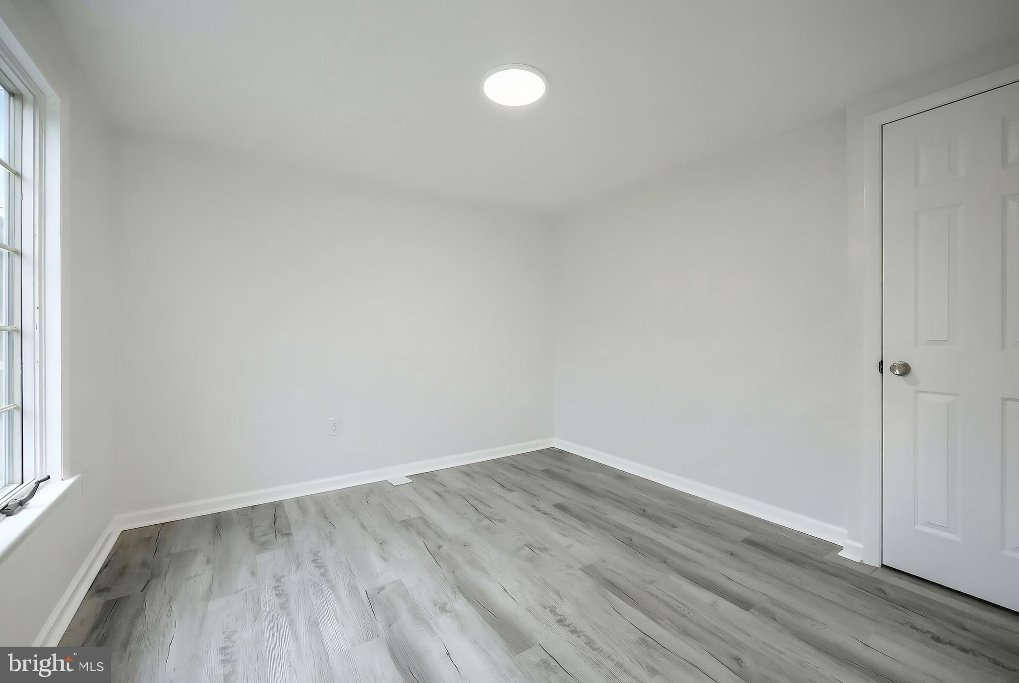 287 Chestnut Hill Road York, PA 17402 - Photo 14 of 36 a view of an empty room with wooden floor and a window