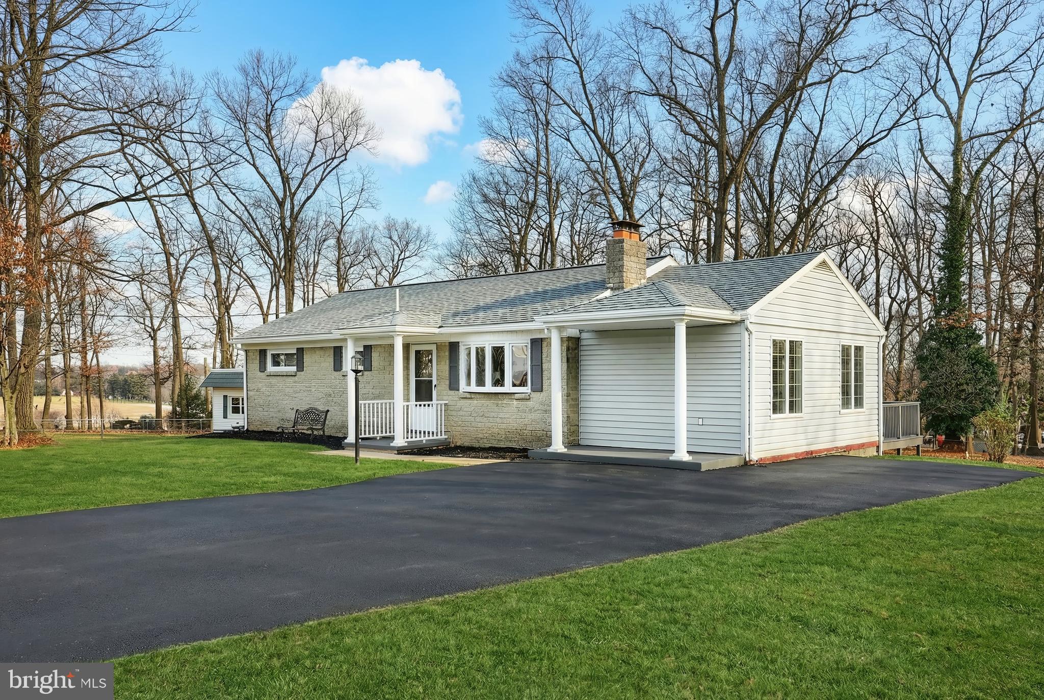 287 Chestnut Hill Road York, PA 17402 - Photo 31 of 36 a front view of a house with a garden and trees