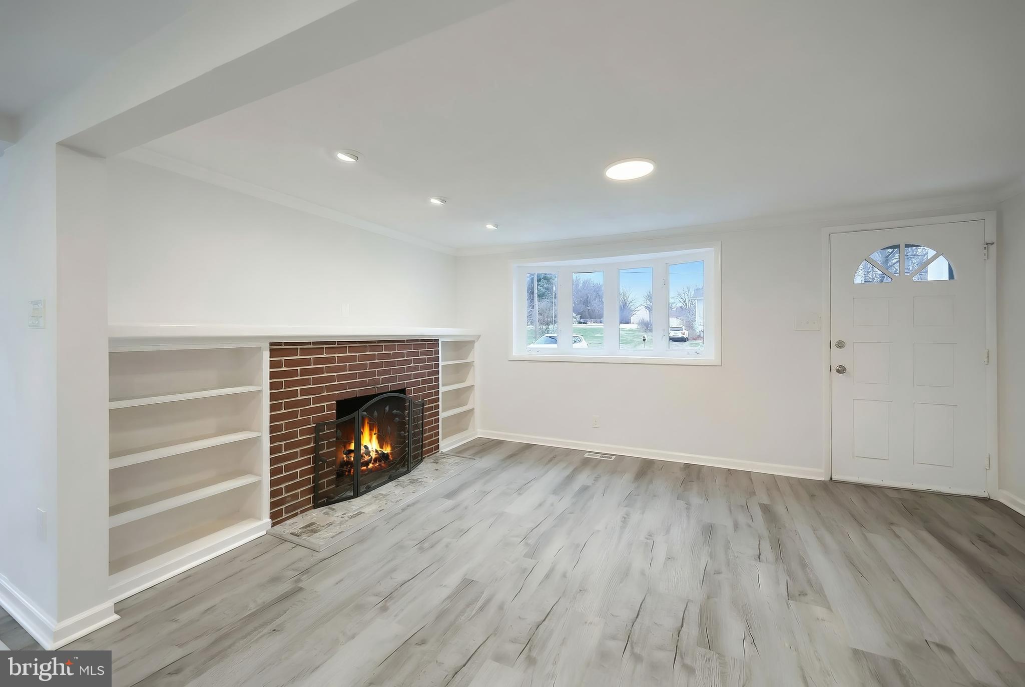 287 Chestnut Hill Road York, PA 17402 - Photo 9 of 36 a view of an empty room with wooden floor fireplace and a window