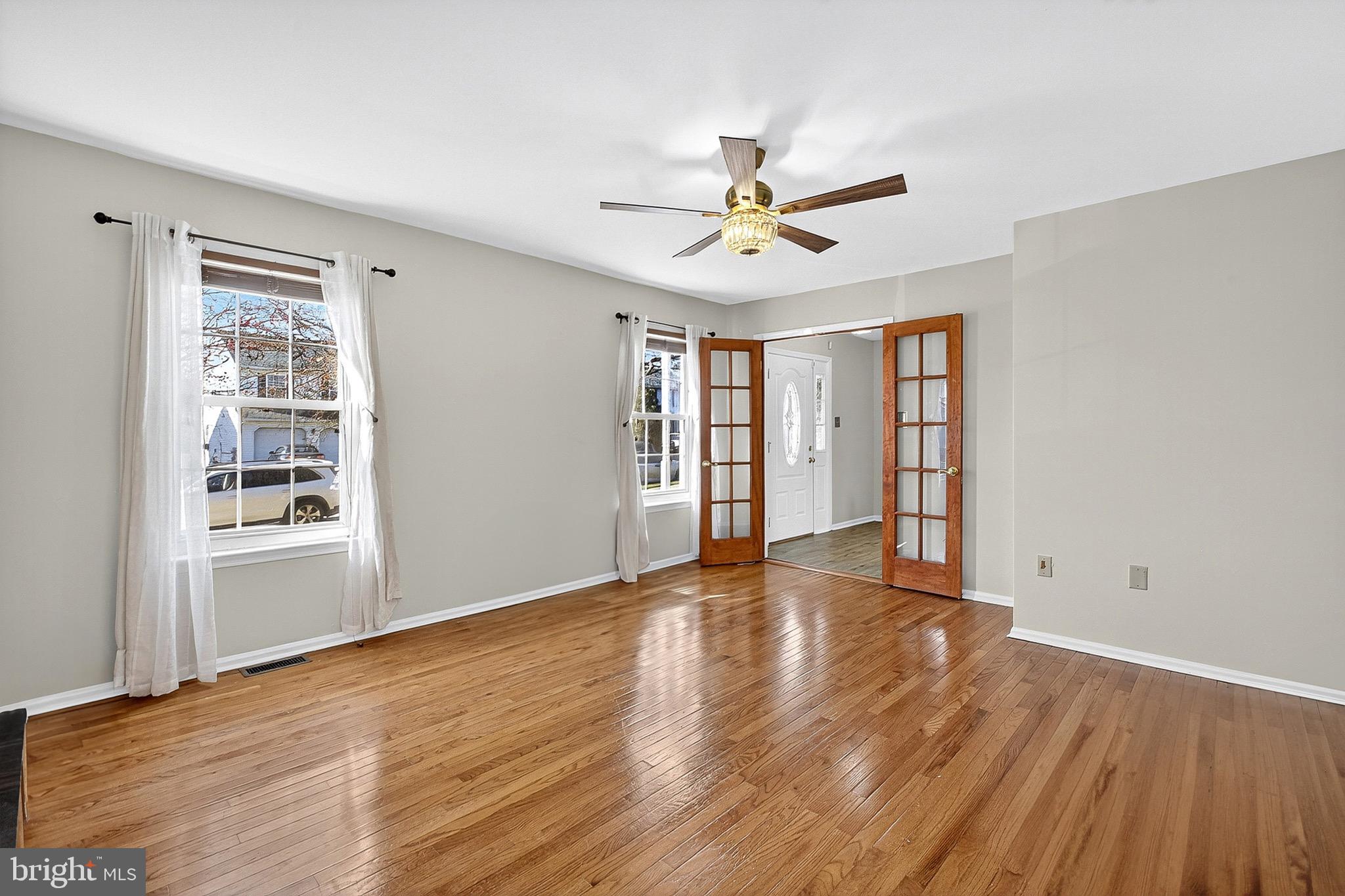 221 Romeo Drive New Castle, DE 19720 - Photo 12 of 38 a view of an empty room with a window and wooden floor