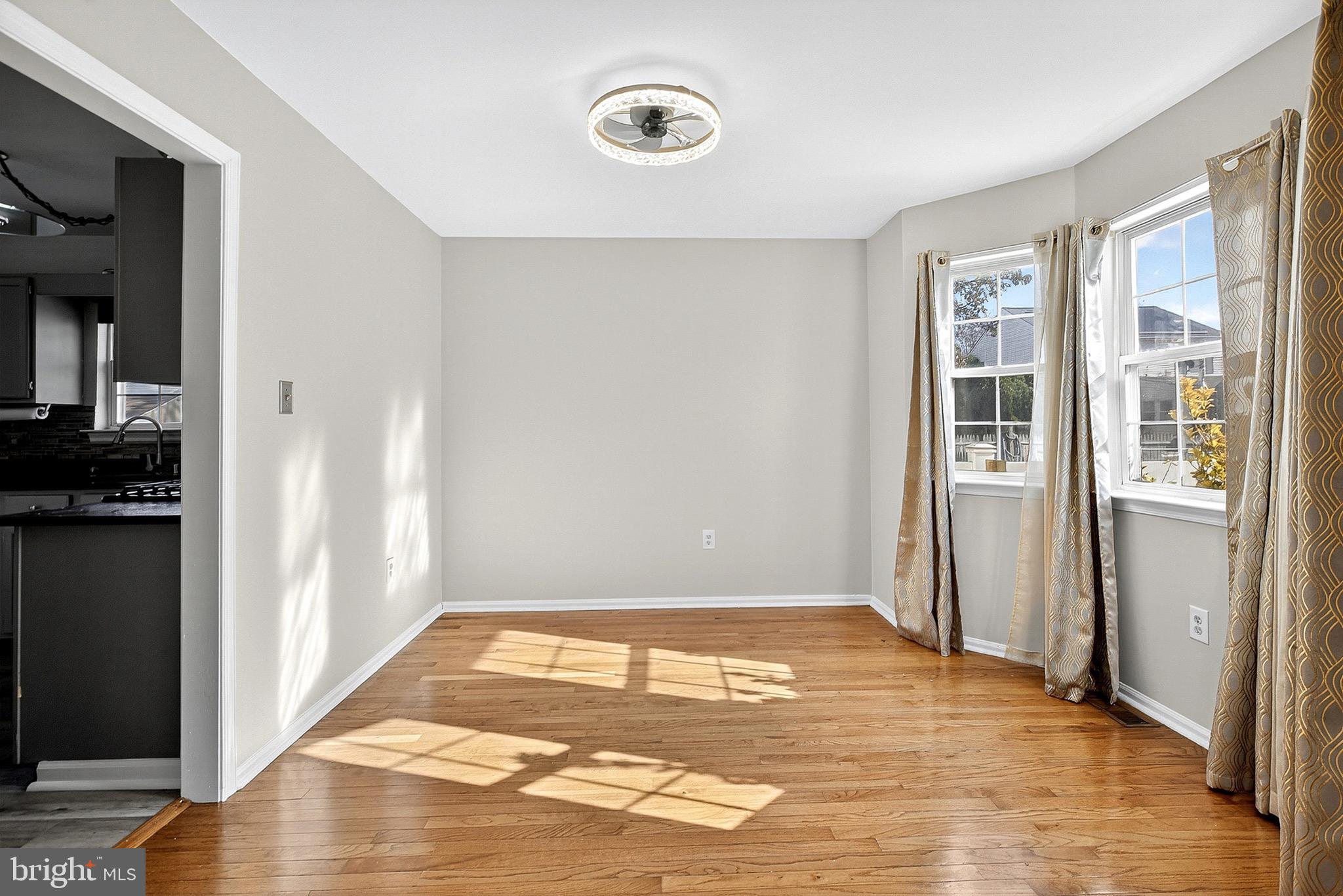 221 Romeo Drive New Castle, DE 19720 - Photo 13 of 38 a view of an empty room with wooden floor and a window