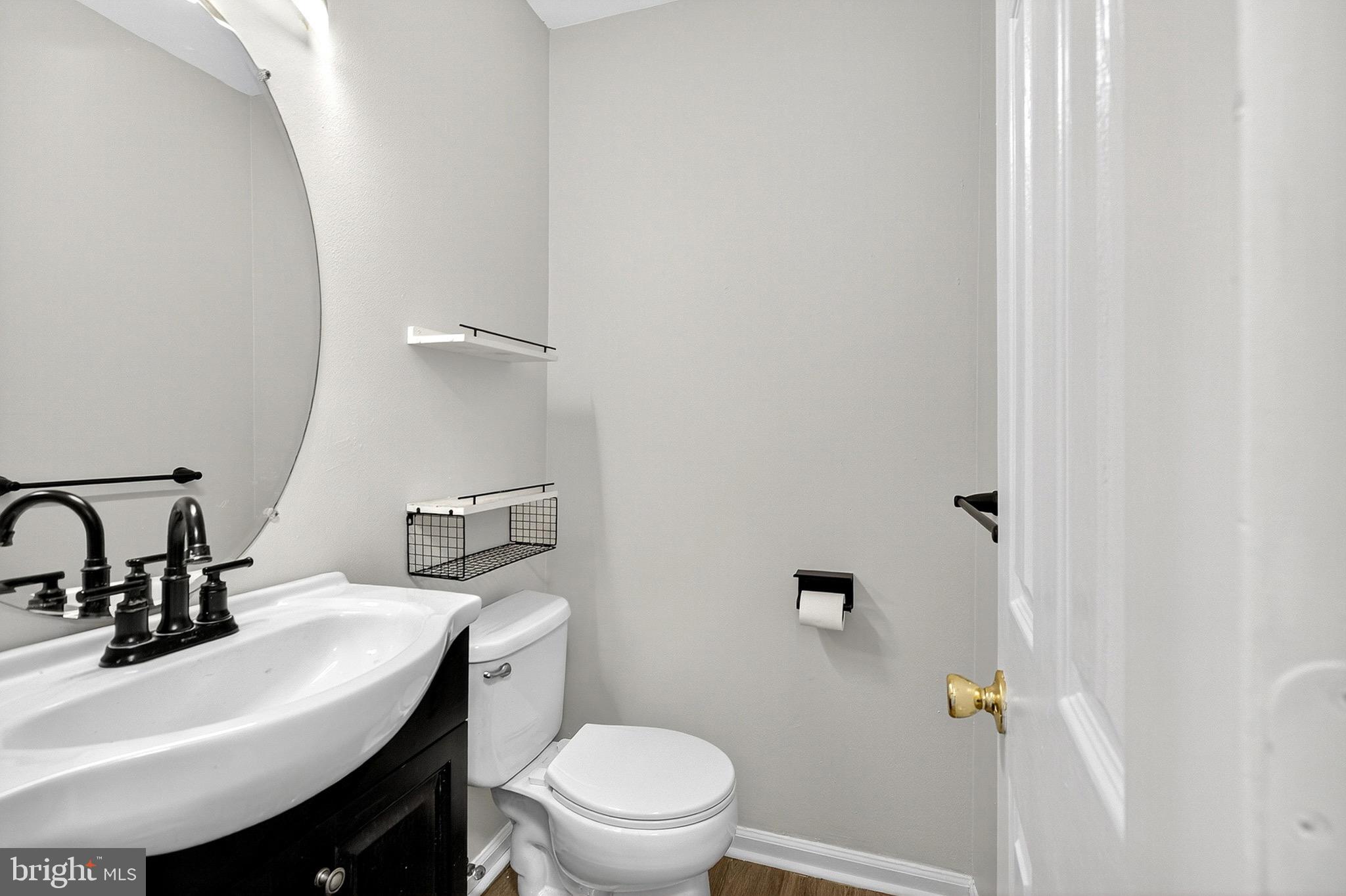 221 Romeo Drive New Castle, DE 19720 - Photo 24 of 38 a bathroom with a sink toilet and a mirror