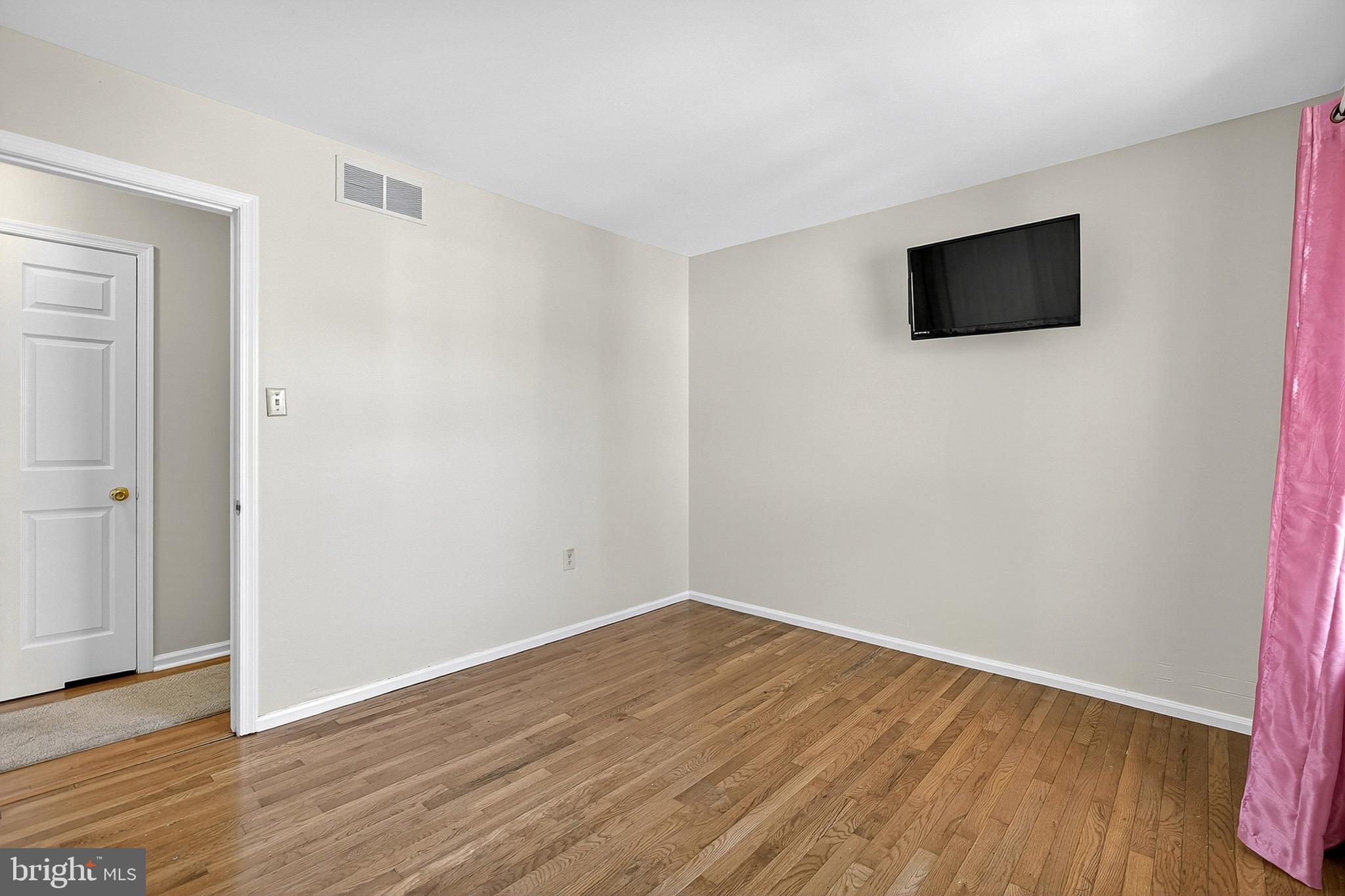 221 Romeo Drive New Castle, DE 19720 - Photo 27 of 38 a view of empty room with wooden floor and fan