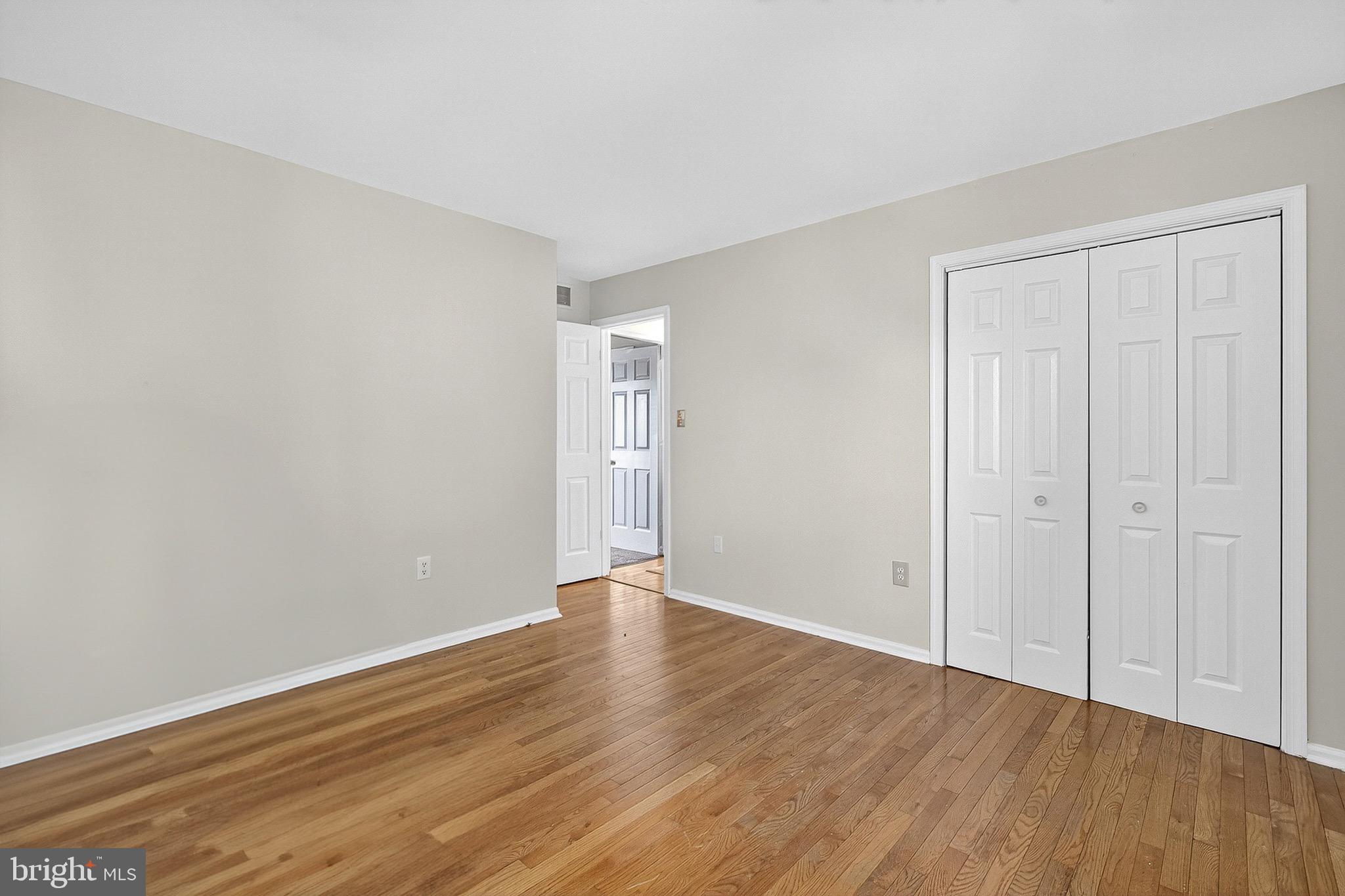 221 Romeo Drive New Castle, DE 19720 - Photo 31 of 38 a view of an empty room with wooden floor