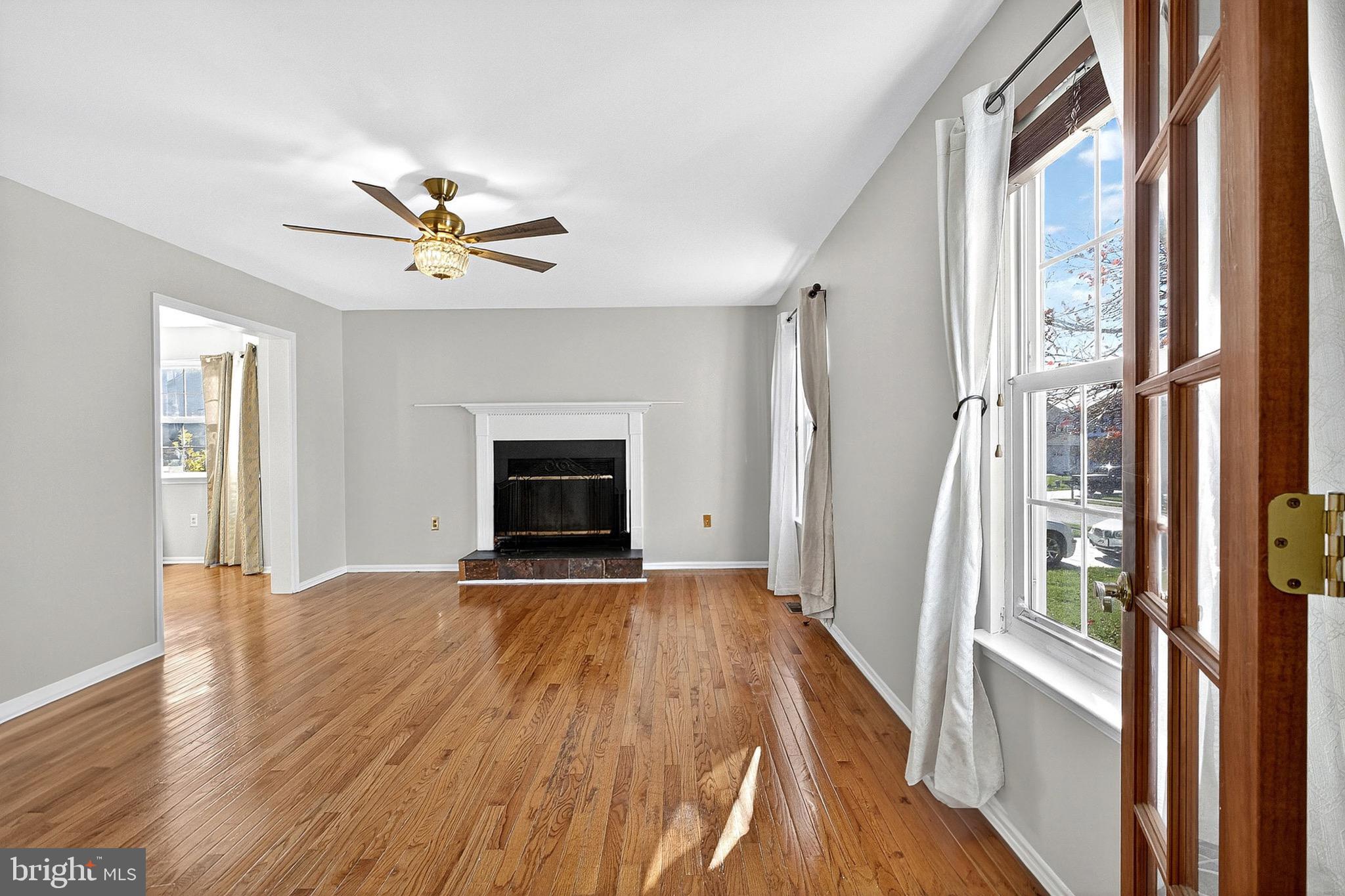221 Romeo Drive New Castle, DE 19720 - Photo 8 of 38 a view of an empty room with a fireplace and a window