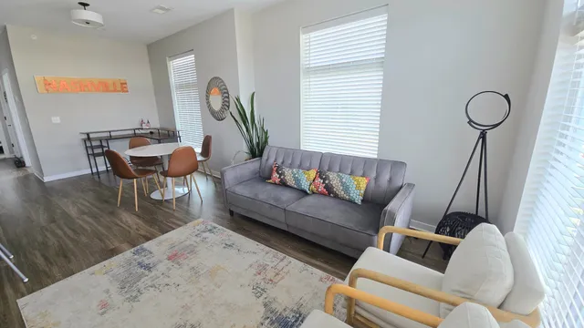 a living room with furniture and a wooden floor