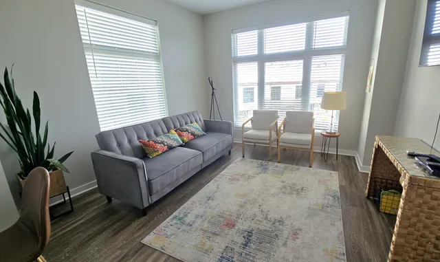 a living room with furniture and a flat screen tv