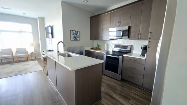 a kitchen that has a sink and a stove in it