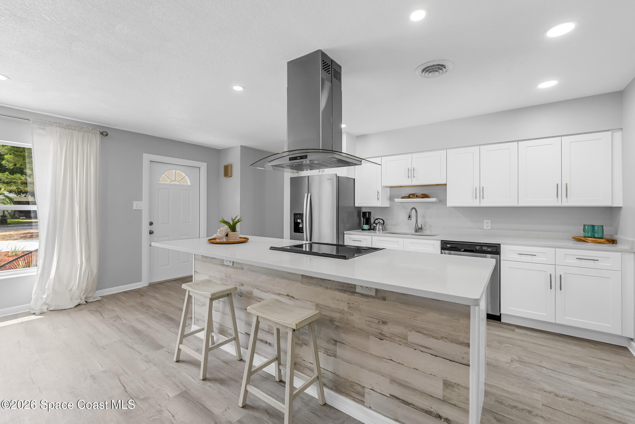 24 Hardee Circle South Rockledge, FL 32955 - Photo 6 of 6 a kitchen with stainless steel appliances kitchen island granite countertop a stove and white cabinets