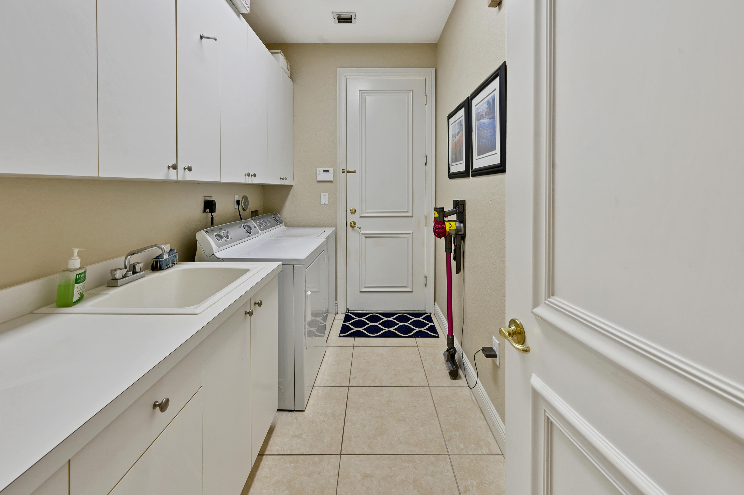 11840 Bayfield Drive Boca Raton, FL 33498 - Photo 14 of 28 a utility room with cabinets washer and dryer