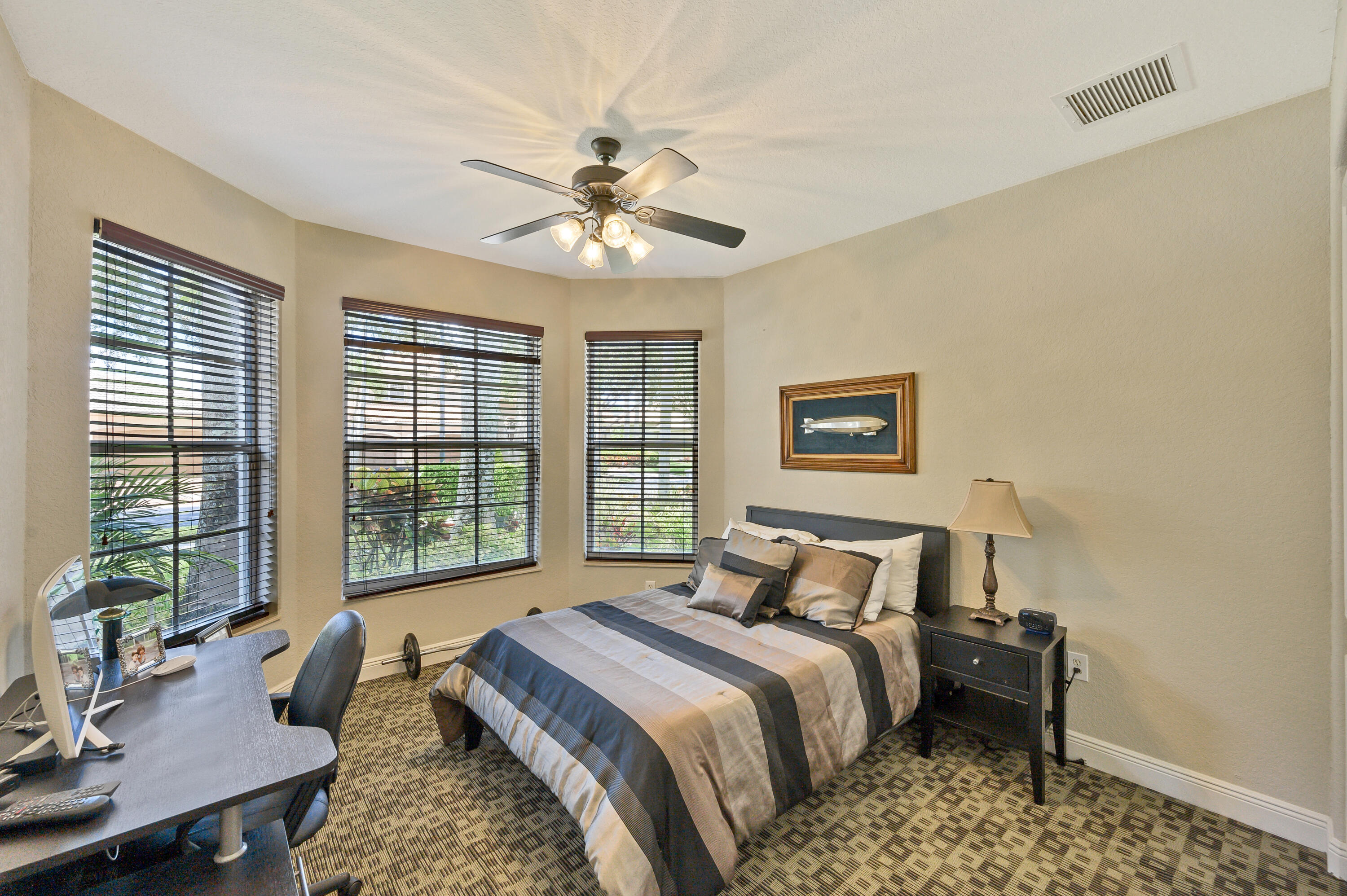 11840 Bayfield Drive Boca Raton, FL 33498 - Photo 15 of 28 a bedroom with a large bed and a chandelier