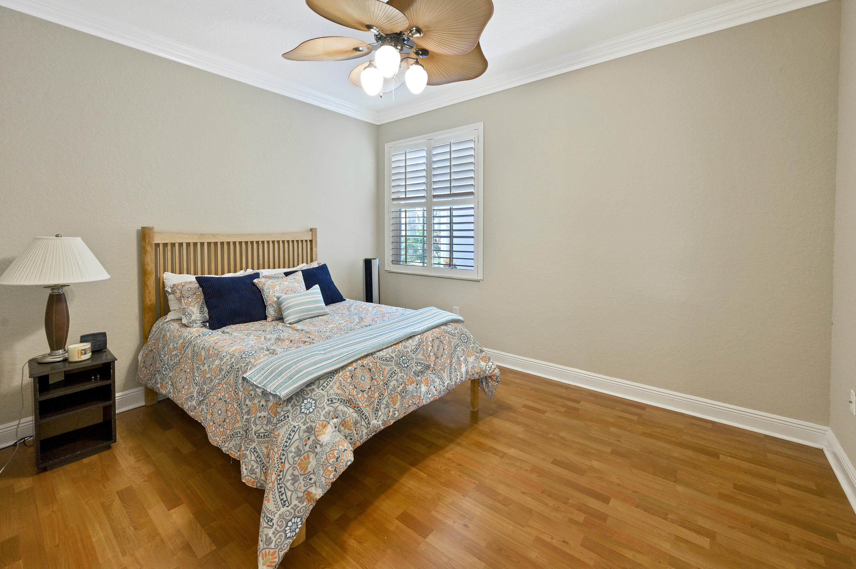 11840 Bayfield Drive Boca Raton, FL 33498 - Photo 18 of 28 a bedroom with a bed and a chandelier