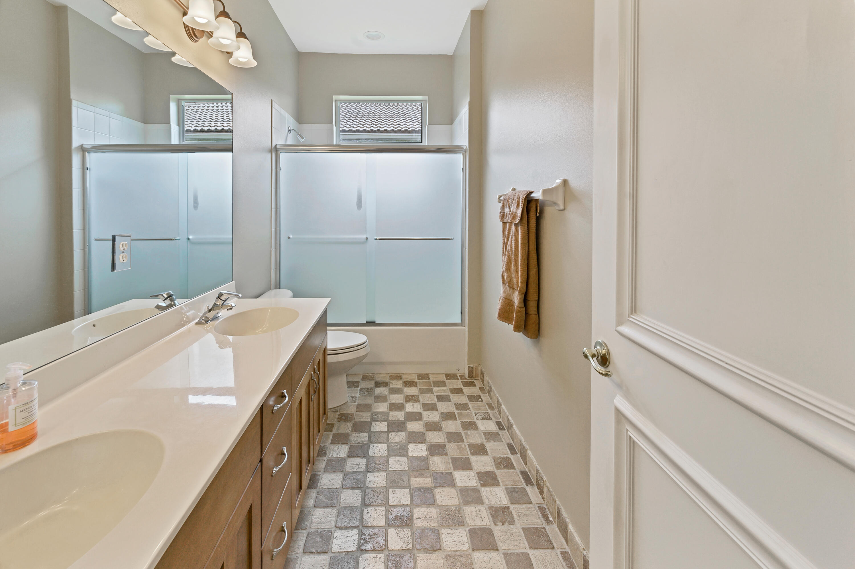 11840 Bayfield Drive Boca Raton, FL 33498 - Photo 19 of 28 a bathroom with a sink a mirror and shower