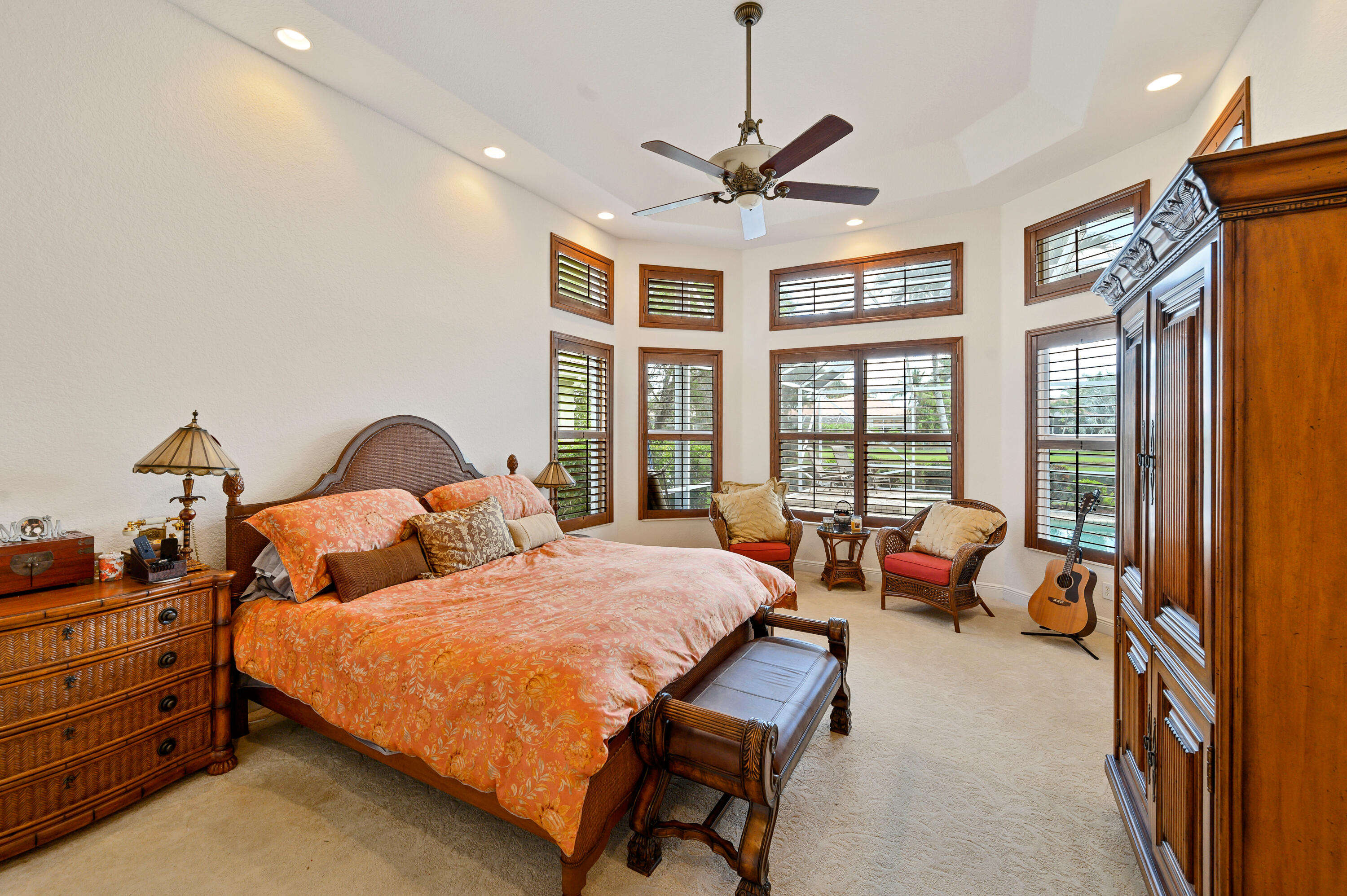11840 Bayfield Drive Boca Raton, FL 33498 - Photo 22 of 28 a spacious bedroom with a bed and a chandelier