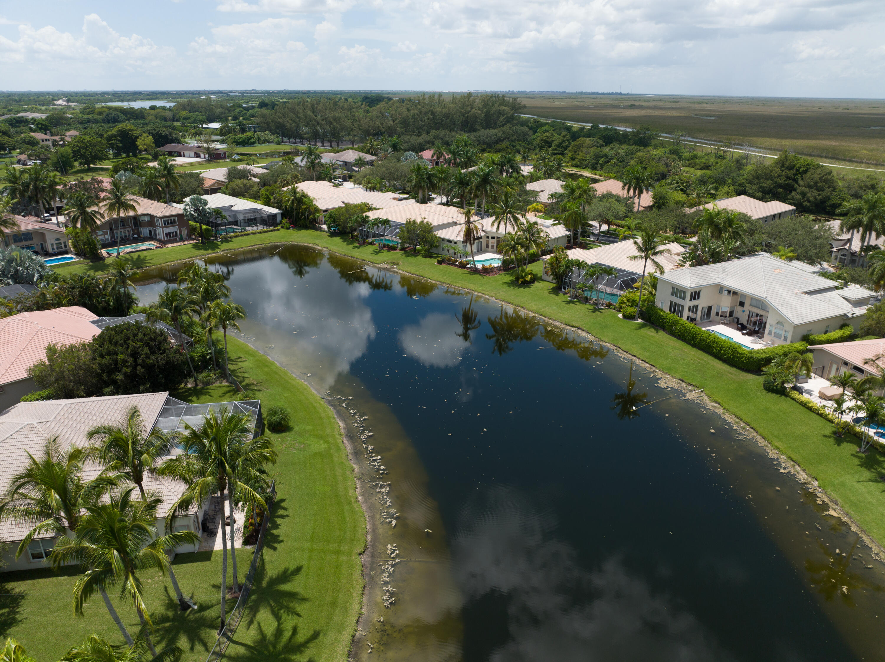 11840 Bayfield Drive Boca Raton, FL 33498 - Photo 25 of 28 an aerial view of city lake and trees