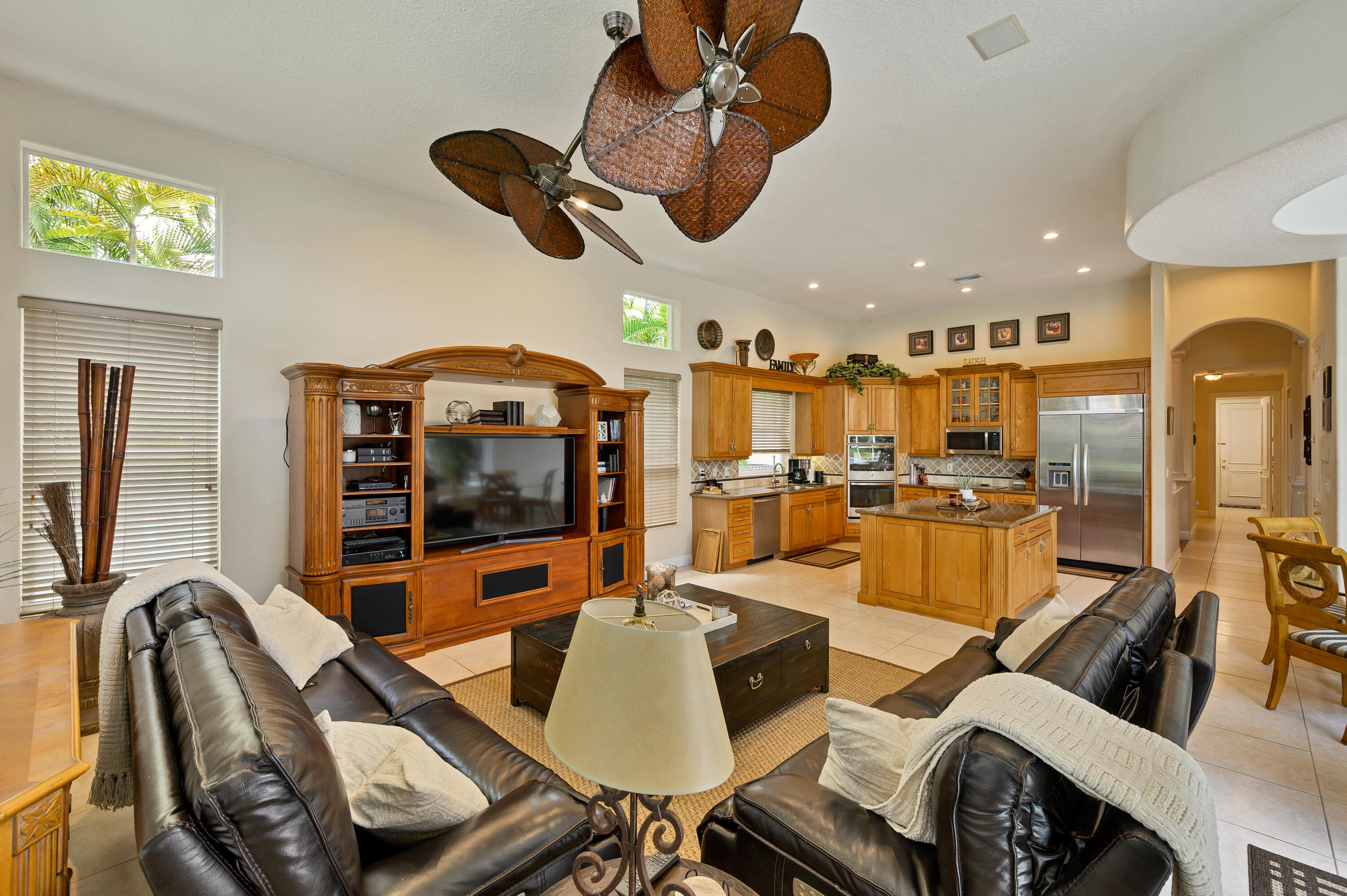 11840 Bayfield Drive Boca Raton, FL 33498 - Photo 9 of 28 a living room with furniture a flat screen tv and kitchen view