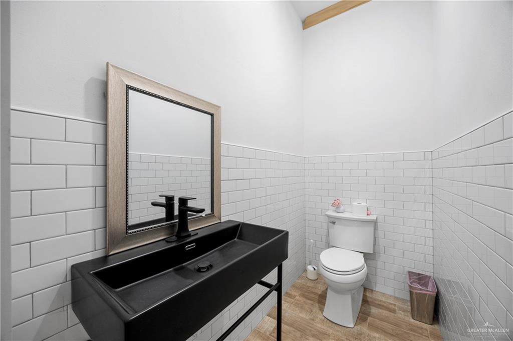 2860 North Fm 2360 Rio Grande City, TX 78582 - Photo 19 of 32 a bathroom with a toilet a sink and mirror