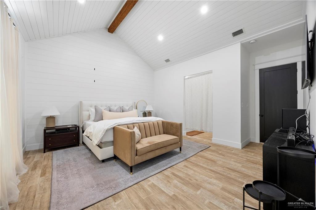 2860 North Fm 2360 Rio Grande City, TX 78582 - Photo 9 of 32 a spacious bedroom with a bed and wooden floor
