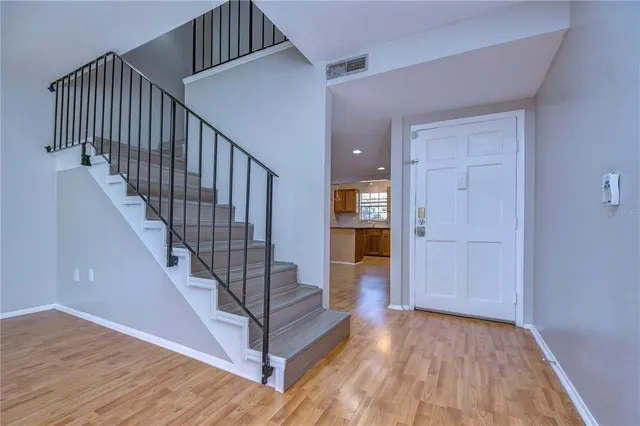 a view of entryway and hall with wooden floor