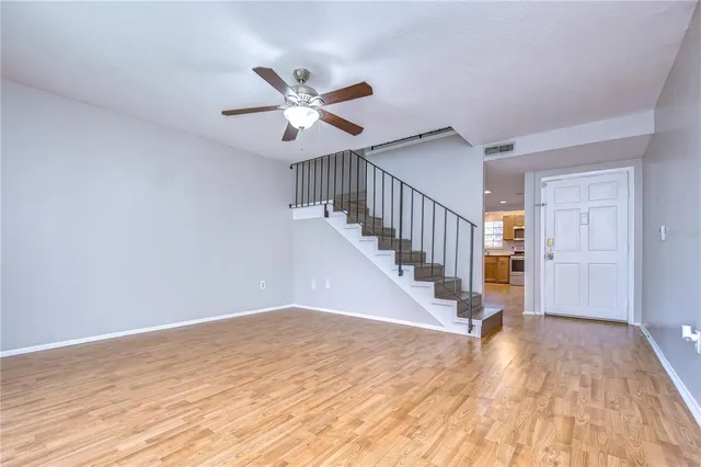 a view of staircase with white walls and railing