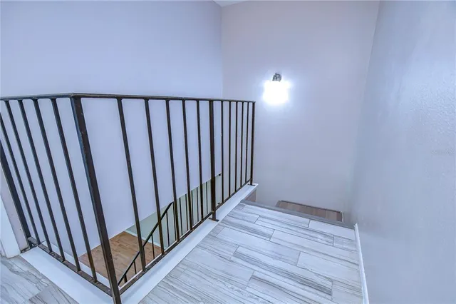 a view of a room with wooden floor and stairs