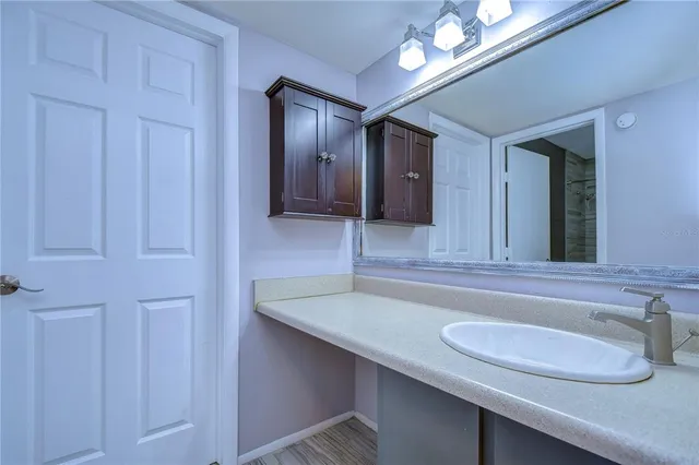 a bathroom with a bathtub shower sink vanity and toilet