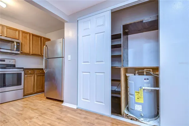 a view of cabinets and refrigerator